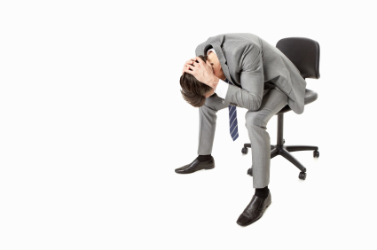 Portrait of a frustrated business man on chair against white - copyspace